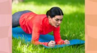 fit, focused brunette woman holding a forearm plank on a yoga mat on the lawn