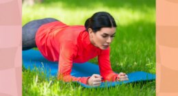 fit, focused brunette woman holding a forearm plank on a yoga mat on the lawn