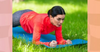 fit, focused brunette woman holding a forearm plank on a yoga mat on the lawn