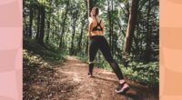 fit woman walking uphill on trail in the woods for exercise