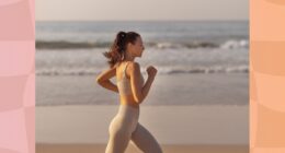 fit brunette woman jogging on the beach at sunset