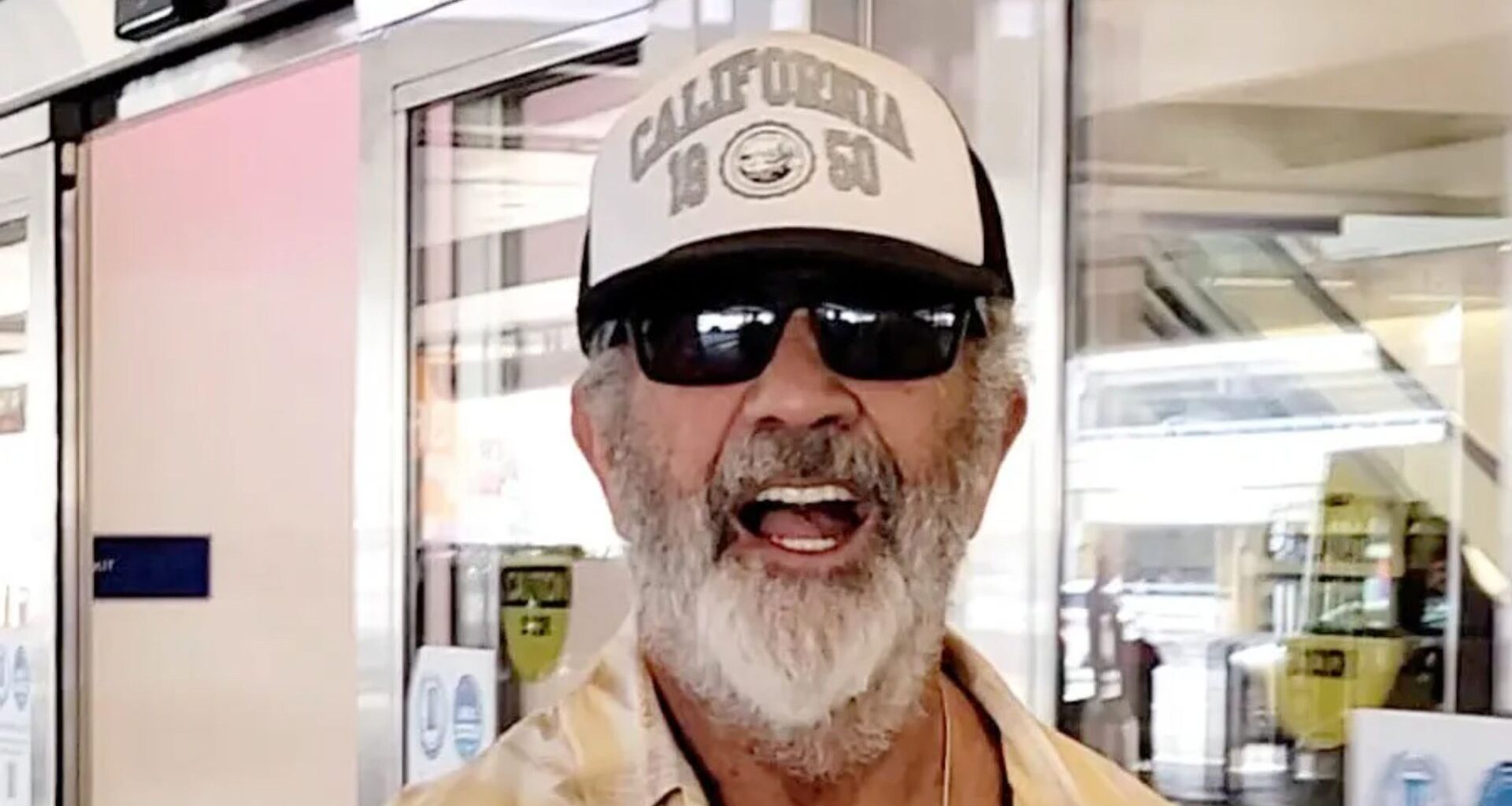 Hollywood superstar goes incognito as he lands in LA with a wild bushy white beard