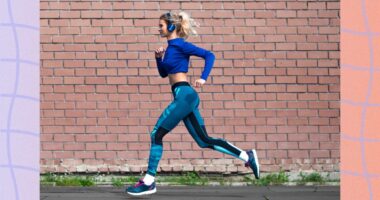 blonde woman with headphones on running outdoors for exercise