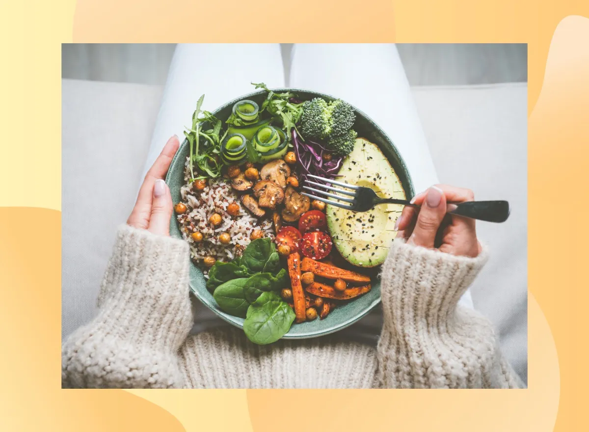 close-up of woman holding a healthy dinner plate filled with grains and vegetables