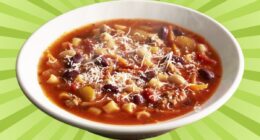 Bowl of Olive Garden Minestrone set on green background