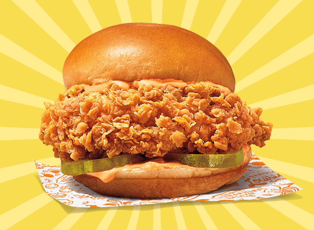 Popeyes new Ghost Pepper Chicken Sandwich set against a vibrant background.