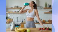 fitness woman drinking a protein shake in bright kitchen