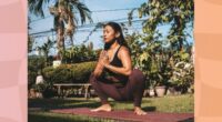 peaceful brunette woman doing yogi squat on mat outdoors in yard on sunny day