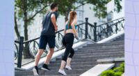 fitness couple brisk walking up staircase outdoors for exercise