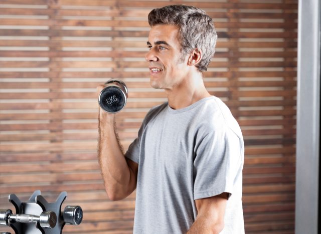 man doing bicep curls, concept of strength exercises for men to lose weight