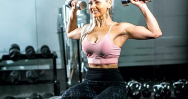 mature, fit, and strong woman holding dumbbells flexing her muscles at the gym, concept of exercises for upper-body strength as you age