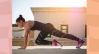 fit, focused brunette woman doing mountain climber exercise outdoors