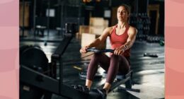 fit, focused brunette woman using a rowing machine at the gym