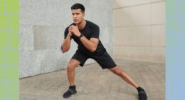 fit, focused man doing lateral lunge outdoors