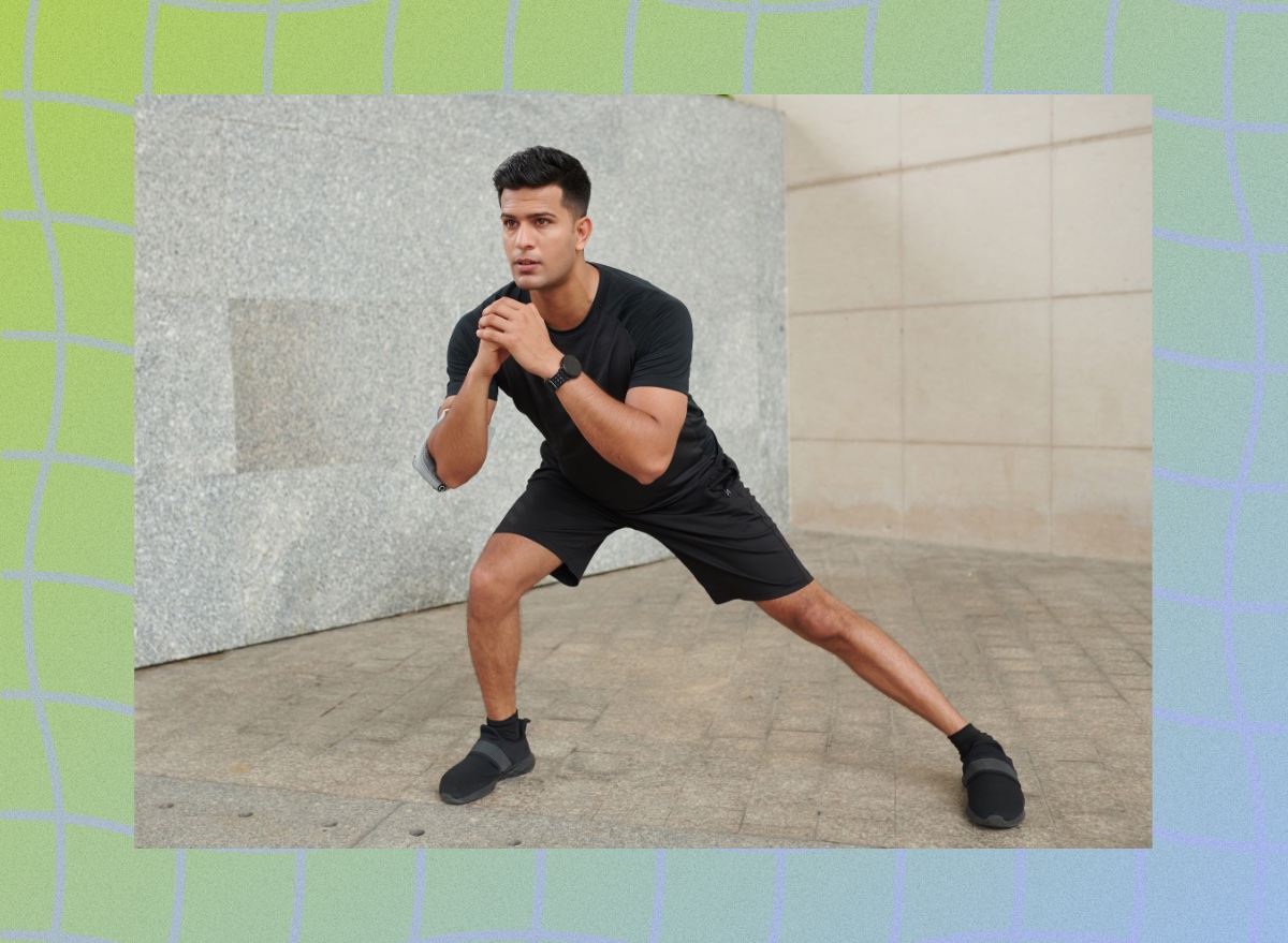 fit, focused man doing lateral lunge outdoors