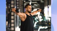 fit, muscular man doing dumbbell lateral raise exercise at the gym