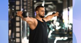 fit, muscular man doing dumbbell lateral raise exercise at the gym