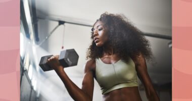 fit woman lifting dumbbells at the gym