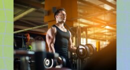 fit, muscular man lifting dumbbells at the gym