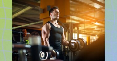 fit, muscular man lifting dumbbells at the gym