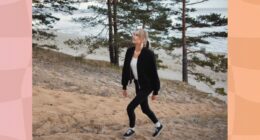 blonde woman walking uphill at the beach