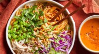 Bowl of pumpkin pad thai with peanuts ready to be eaten