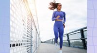 fit brunette woman running outdoors on bridge on fall or winter day