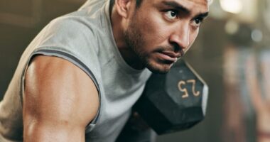 man lifting weights, concept of fitness rules to abandon for the best results