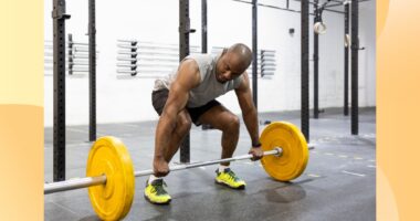 fit man doing a barbell deadlift at the gym