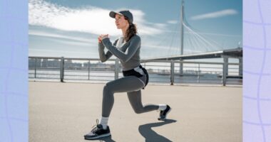 woman doing lunges outdoors at waterfront in cold weather