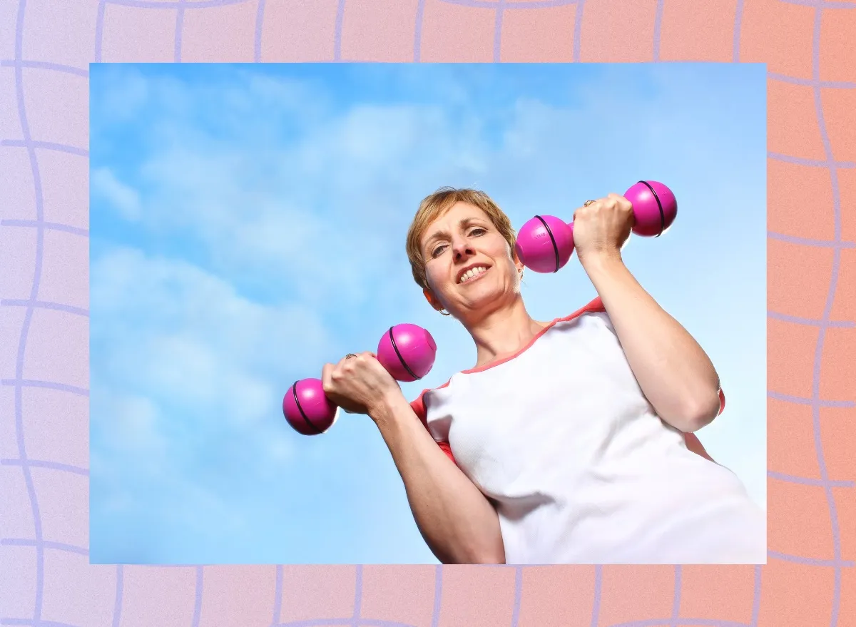 mature woman lifting weights outdoors with blue sky behind her