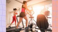 lineup of a treadmill, elliptical, and exercise bike at the gym in front of floor-to-ceiling windows with sun shining through