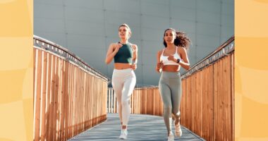 two fit women running outdoors on small bridge