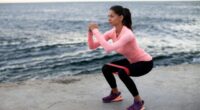 fitness woman doing banded squats, concept of resistance band exercises to burn body fat