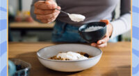 woman spooning yogurt into a bowl surrounded by a blue border