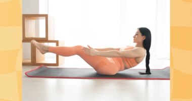 focused woman doing v-up exercise on yoga mat at home