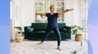 fit, mature woman doing yoga exercise in bright living space