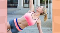 close-up of fit blonde woman doing side plank exercise on cobblestone