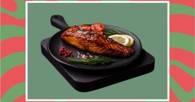 a photo of festive plate of salmon on a designed holiday-themed background