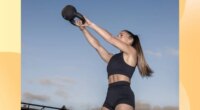 fit woman doing kettlebell swing outdoors at dusk