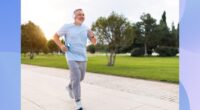 mature man running outdoors on paved trail in park