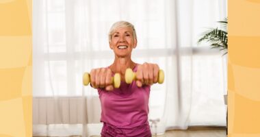 fit, mature woman lifting dumbbells at home in bright living space