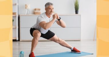 fit, mature man doing side lunges at home on yoga mat in bright living space