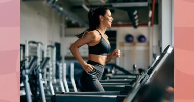 fit, focused brunette woman running on the treadmill at the gym