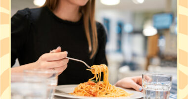 woman eating a plate of pasta