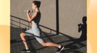 woman doing dumbbell walking lunges outdoors