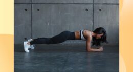 fit brunette woman holding a forearm plank