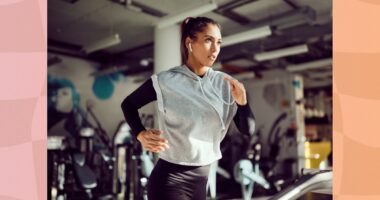 fit brunette woman running on treadmill at the gym