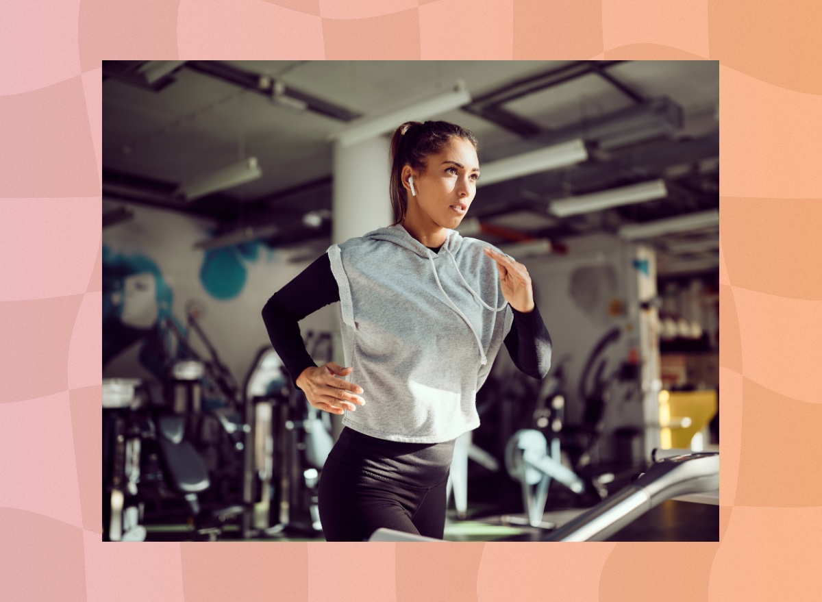 fit brunette woman running on treadmill at the gym