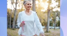 mature, happy woman walking outdoors in the park on fall day